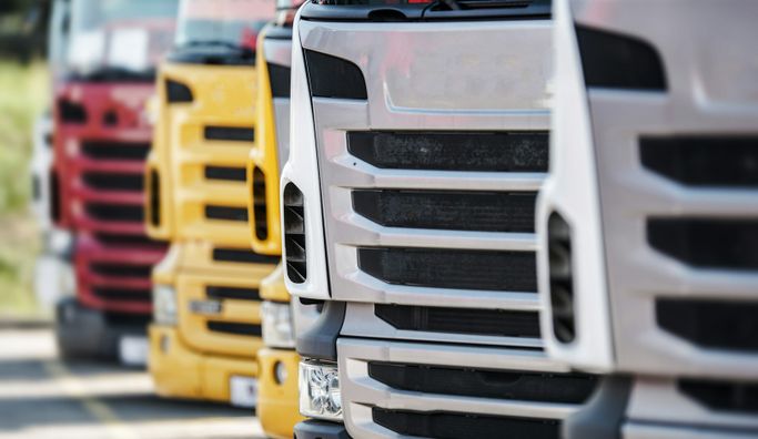 A commercial fleet of trucks and vans on the road